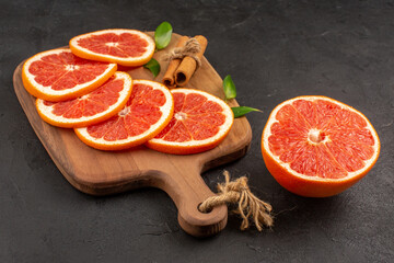 front view fresh grapefruit slices on dark background diet fresh color fruits juice healthy life
