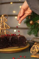 Festive atmosphere in the kitchen. Hand and part of the cake in focus