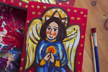 The angel is drawn on a board in ancient style of painting.