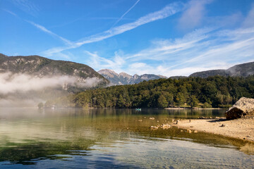 A beautiful mountain lake in an early foggy morning in Slovenia.