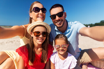 family, leisure and people concept - portrait of happy mother, father and two daughters in...