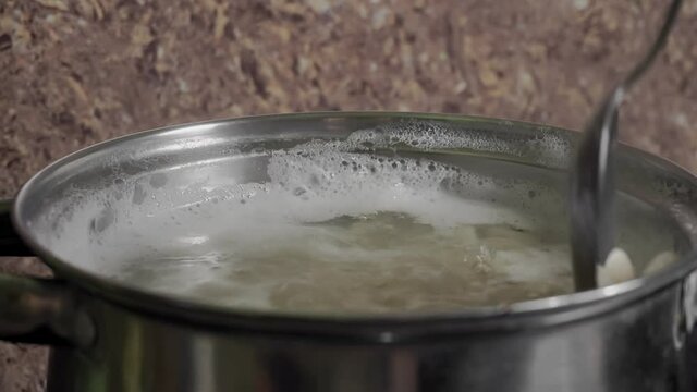 Beans Cooking Process White bean seeds in boiling water in a saucepan. High quality 4k footage