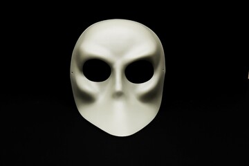 white carnival mask isolated on dark ground