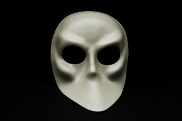 white carnival mask isolated on dark ground