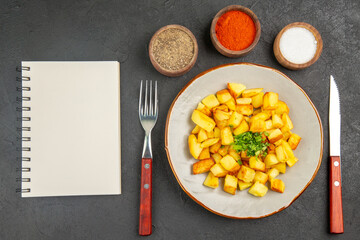 top view tasty fried potatoes inside plate with seasonings on a dark background photo food oil color dinner bread