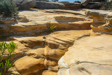 Colorful limestone rocks along the Coogee - Bondi Coastal Walk near Sydney, New South Wales, Australia