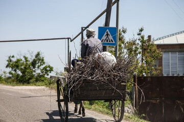a man on a wagon with firewood