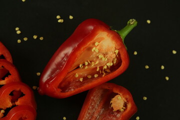 Red peppers on black background