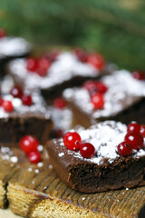 Selective focus. Christmas chocolate brownies with cranberries. Festive sweets.