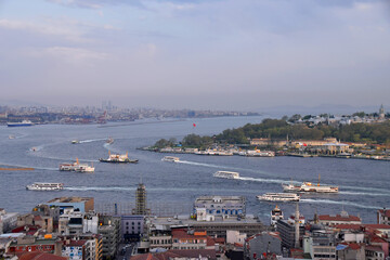 Fototapeta na wymiar Ferries sail through the Bosphorus, Istanbul, Turkey. Photo taken from Galata tower