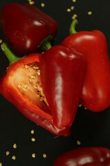 Red peppers on black background