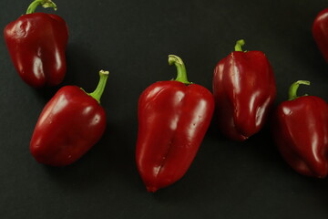 Red peppers on black background