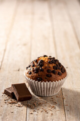 Just baked chocolate muffins on wooden table. Copy space
