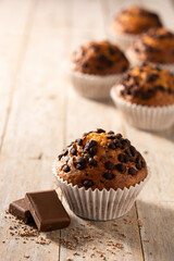 Just baked chocolate muffins on wooden table. Copy space