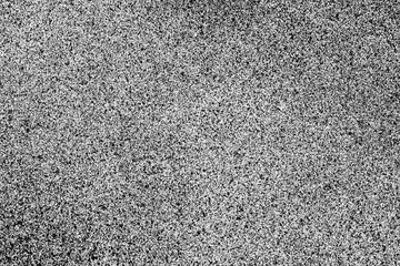 Abstract closeup black spray dots paint on white paper.