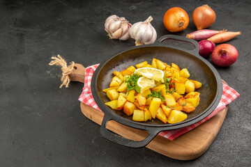 front view fried potatoes inside pan with lemon on dark-grey background cuisine meal food color