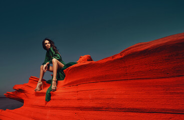 Beautiful girl in green drees in the desert