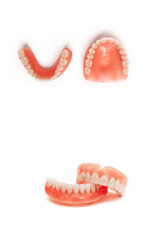 Dentures on a white background. Acrylic denture on white background. Full denture close-up. Full removable plastic denture of the jaws. Isolate on white background acrylic prosthesis of human jaws