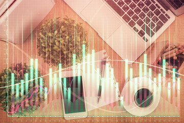 Multi exposure of financial chart hologram over desktop with phone. Top view. Mobile trade platform concept.