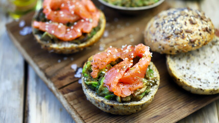 Salmon avocado sandwiches on buns with seeds. The keto diet. Healthy breakfast or snack.