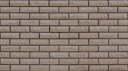 Brick beige with gnawed and chipped surfaces texture. Tiling clean for background pattern.