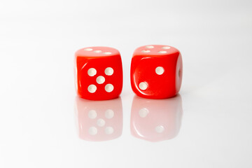 Two red dice with  number five and two on white background.