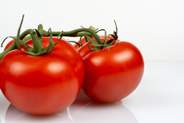 a bunch of large tomatoes on a white background