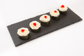 Japanese seafood sushi, roll on shale food board on white background