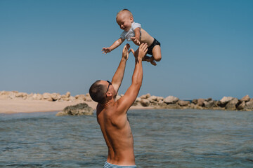 Fototapeta na wymiar Happy family. Father and son spend time by the sea. Happy father's day