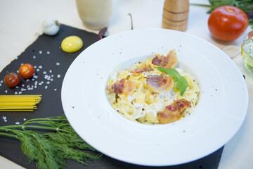 Pasta with bechamel sauce. Ingredients for spaghetti on a black background.