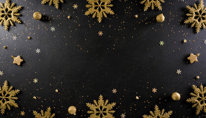 Christmas and New Year holidays background concept made from christmas ball, stars, snow flake with golden glitter on black wooden background.