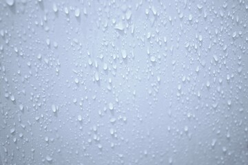 Naklejka na ściany i meble Blurred many water droplets on white bathroom wall with soft light for background backdrop