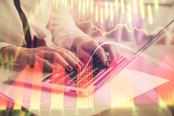 Multi exposure of woman hands typing on computer and financial graph hologram drawing. Stock market analysis concept.