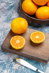 front view fresh tangerine slices on light-blue background citrus juice fruit tree color photo