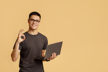 Excellent result, good feedback and vin. Smiling male in glasses expresses emotions of success