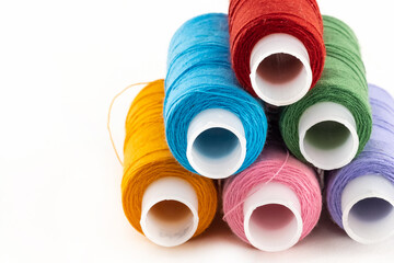 stack of pink, orange and blue moto threads on a white isolated background