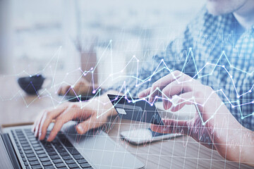 Double exposure of man hands holding a credit card and Forex graph drawing. Stock trading and digital fintech in Internet E-commerce concept.