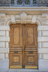 French wooden door Haussmann facade Paris France