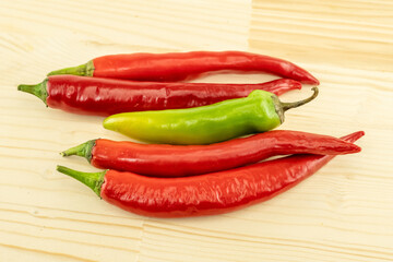 set of four horizontal chili peppers red and green pod nea wooden background
