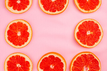 top view tasty grapefruits sliced juicy fruits lined on pink background juice fresh fruit color diet