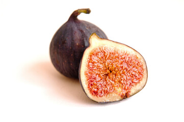 Fresh whole and bisected figs isolated on white background.
