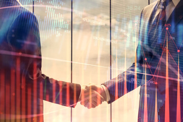 Double exposure of forex graph hologram and handshake of two men. Stock market concept.