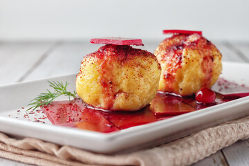 Swedish potato dumplings with cranberry sauce on a light background