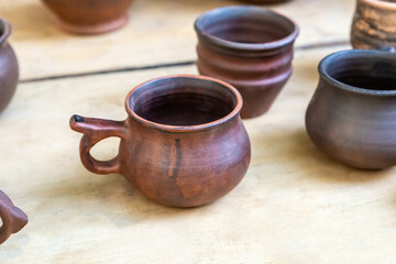 traditional clay mug for beer stands next to the decanter