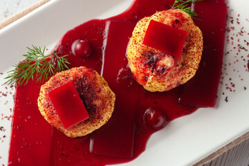 Swedish potato dumplings with cranberry sauce on a light background