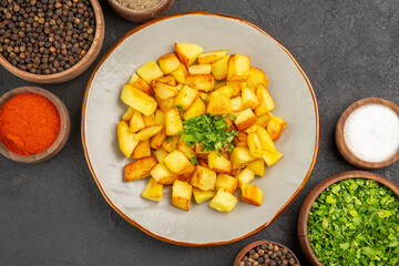 top view tasty fried potatoes inside plate with seasonings on dark background food color kitchen photo