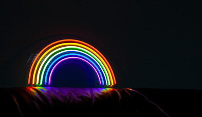 The led neon rainbow shines in the dark room