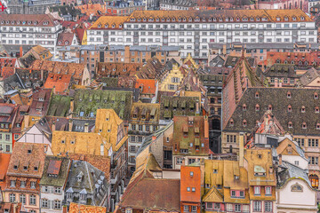Fototapeta premium Aerial view of Strasbourg old city with red roof tiles. France. Strasbourg is the capital and principal city of Alsace region in eastern France and is official seat of European Parliament.