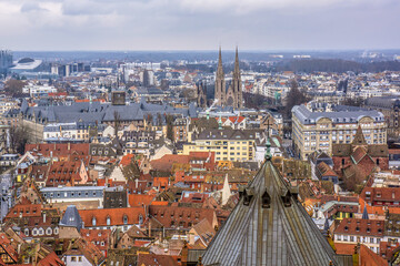 Obraz premium Aerial view of Strasbourg old city with red roof tiles. France. Strasbourg is the capital and principal city of Alsace region in eastern France and is official seat of European Parliament.