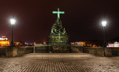 Prague, Czech Republic-January 31, 2019. Night scene. Statue of the Lamentation of Christ on the south side of the Charles bridge, depicts Mary Magdalene and the Virgin Mary mourning the dead Christ. 
